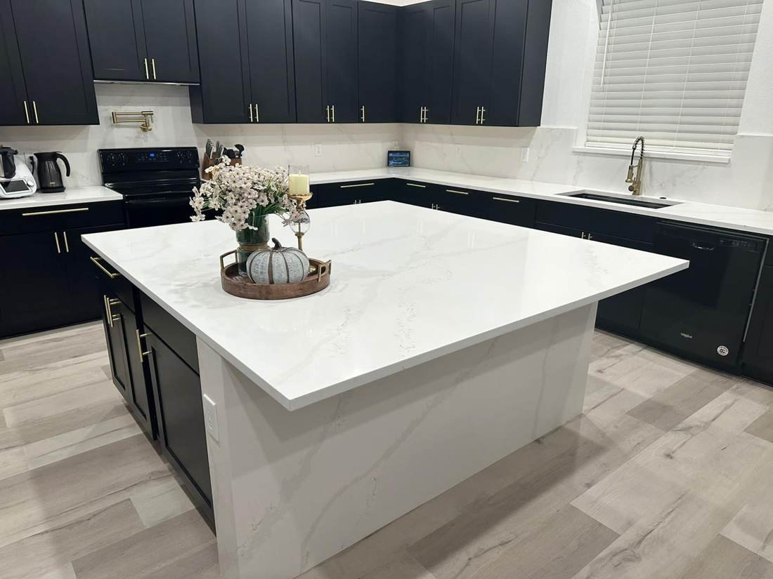 White quartz kitchen island with navy cabinets